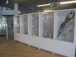 A collection of ski jumping cups exhibited at a the newly established <!--LINK'" 0:13--> in the pavilion of the Nordic Centre Planica, 2016.
